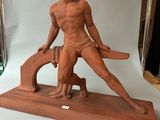 statue of a man holding a baseball bat on top of a wooden base
