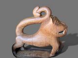 a wooden sculpture of a monkey on a stand