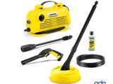 a yellow pressurer with a hose and other cleaning supplies