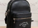 a small black backpack with a zipper on it sitting on a wooden table