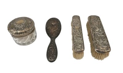 three silverware items including a brush, spoon, and a jar