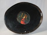 a painting of a woman in a red dress on a black plate