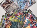 a pile of pokemon cards sitting on top of a table