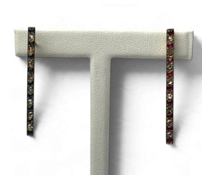 un gros plan sur une paire de boucles d'oreilles ornées de pierres multicolores