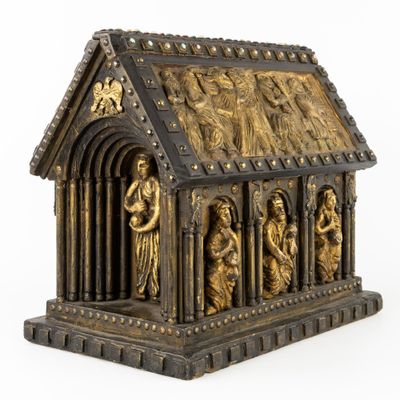 an image of a gold and black statue of a church