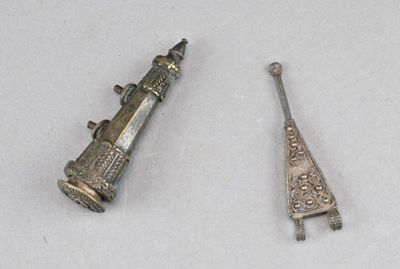 deux petits objets argentés posés sur une surface blanche