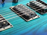 a close up of a blue and black electric guitar