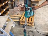 a man that is working on a machine in a room