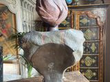 a statue of a woman with a hat on top of a table