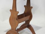 a small wooden table with a magazine rack on it