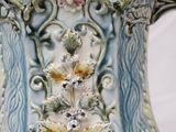 a blue and white vase with flowers on it