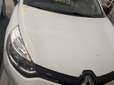 a white car that is parked on the side of the street