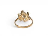 a close up of a gold ring on a white background