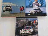 three books on a white table with a picture of a rally car and a group of people