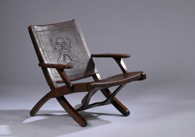 an old wooden chair with a metal plate on the back of it
