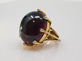 an image of a ring with a large red stone in it