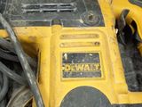 a yellow and black corded drill and a black and white cord
