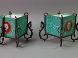 pair of green and red glass candle holders with wrought legs
