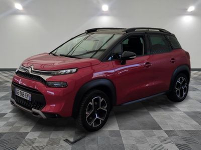 a red citrole is parked on a checkered floor
