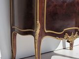 a cabinet that has a glass door on top of it