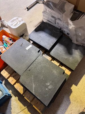 four pieces of concrete on a pallet in a room