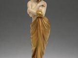 a statue of a woman in a gold dress