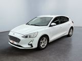 La Ford Focus blanche est garée dans une pièce blanche.
