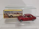 a red toy car in a clear display case