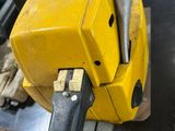 a close up of a chainsaw on a table in a warehouse
