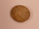 a coin that is sitting on a white surface