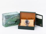 a box with a watch inside of it on a white surface