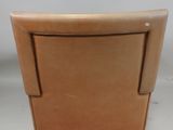 brown leather lounge chair with armrests and foot rest