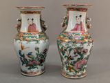 pair of chinese vases decorated with birds and flowers on a gray background