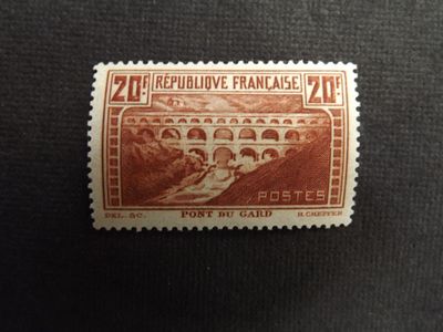 a close up of a stamp with a picture of a bridge on it