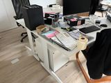 a desk with a computer, keyboard, mouse, and other items on it