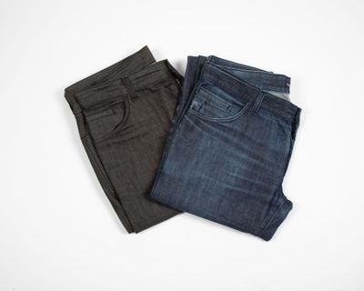 two pairs of men ' s jeans on a white background