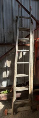 a man that is standing on a ladder in a building
