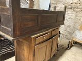 a wooden cabinet with a mirror on top of it