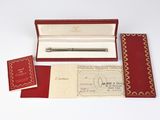 a red box with a pen in it and a red envelope
