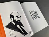 an open book with a drawing of a man in a suit and tie