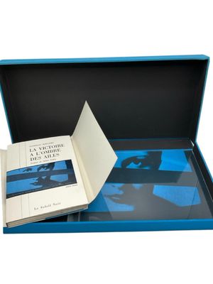 a blue box with a book in it on a white background