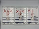 three silver coins in plastic bags on a white surface