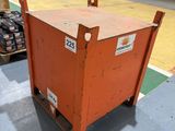 a large orange box sitting on a dolly in a warehouse