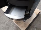 a black stove with a drawer in it on a pallet