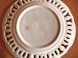 a white plate with holes on it sitting on a brown surface