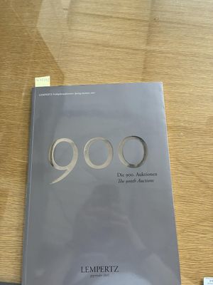 the book is sitting on a table next to a remote control