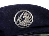 a black hat with a silver emblem on it