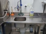 a sink in the middle of a kitchen with a sink and a faucet