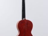 a close up of a guitar hanging from a hook on a wall