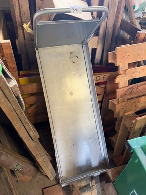 a pile of wooden pallets and a metal object in a room